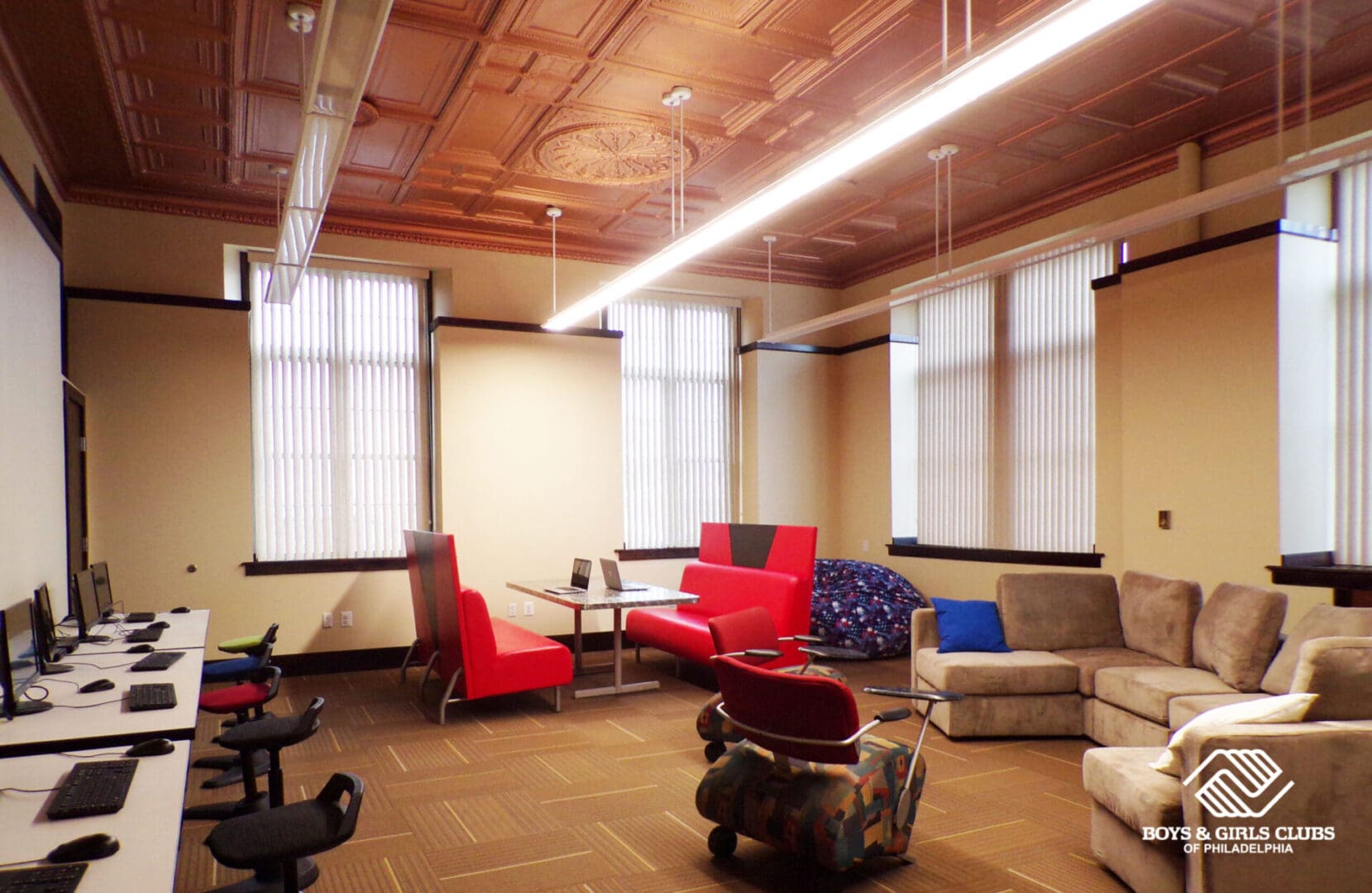 KODAK Digital Still Camera An office space with brown walls, low lights, work desks, and couches